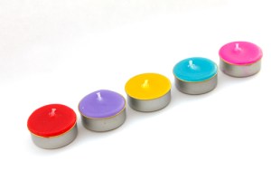 Colorful short candles without flame. Isolated over white background Stock Photo